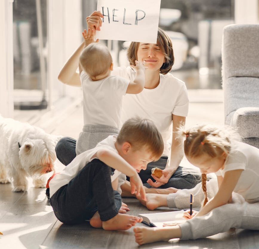 tired mother kidding while sitting with children